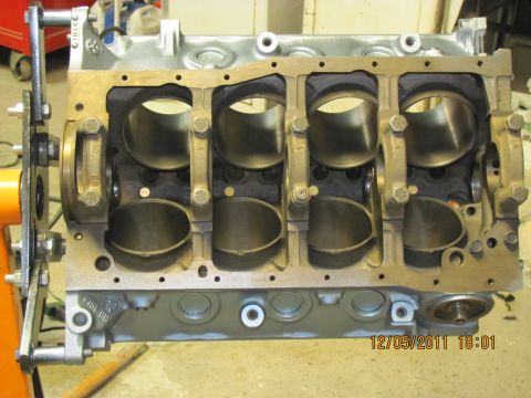 1985 Ford F-150 - Close-up view of an engine block with the crankshaft and connecting rods installed, resting on an engine stand.