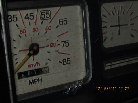 1985 Ford F-150 - Dashboard gauges and odometer reading of a vehicle interior.