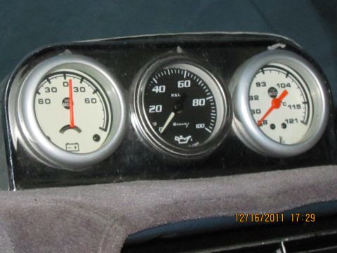 1985 Ford F-150 - A set of aftermarket gauges are installed on the dashboard, showing battery, oil pressure, and temperature readings.