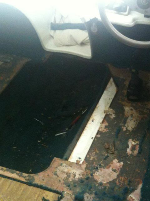 1978 Chevrolet Camaro - The interior of a vehicle is shown, with a focus on the floor and lower dashboard, revealing signs of wear and tear.