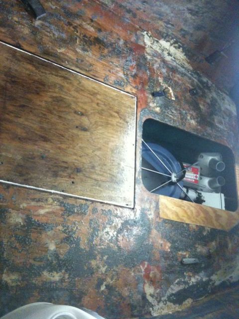 1978 Chevrolet Camaro - Interior view of a boat's compartment, revealing weathered wood and engine parts.