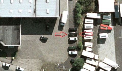 2003 Audi A6 - An aerial view shows several vehicles and trailers parked in an outdoor lot.