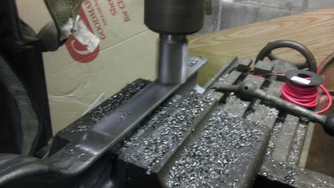 1987 Ford Ranger - A metal part is being machined on a milling machine, creating metal shavings.