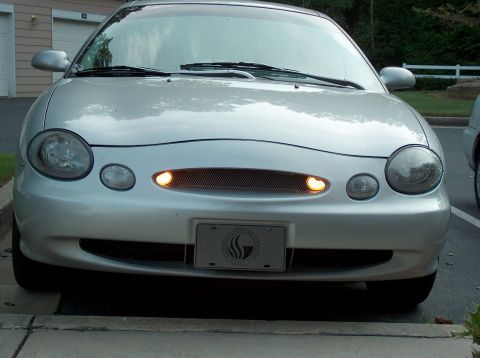 1998 Ford Taurus - Front view of a 1998 Ford Taurus, showing its distinctive grille and headlights.