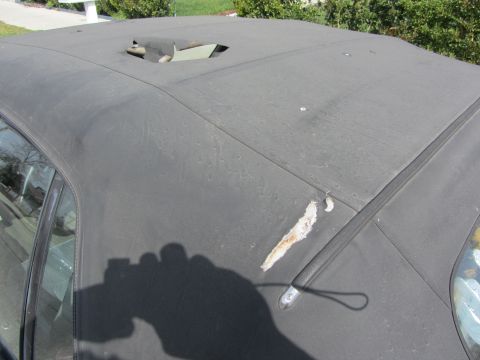 1985 Ford Mustang - Convertible top shows significant damage with a large tear and exposed material.