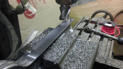 1987 Ford Ranger - A metal part is being machined on a milling machine, creating metal shavings.
