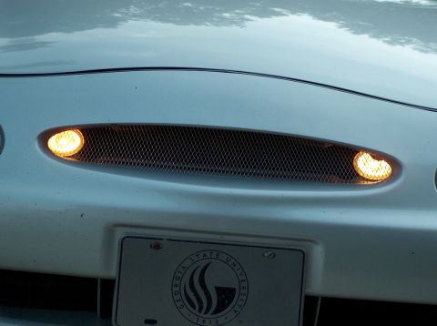 1998 Ford Taurus - The front grille and turn signals of a white vehicle are shown, with a Georgia State University license plate below.