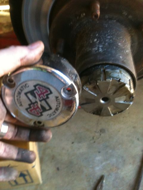 1995 Ford Bronco - A person is holding a locking hub, showing the '4x4 AUTOMATIC' text and logo.