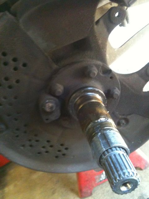 1995 Ford Bronco - This image shows a close-up of a vehicle's front wheel hub and axle assembly, likely during a repair or replacement process.
