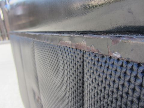 1964 Ford Ranchero - Detail of a textured door panel showing wear and tear on the painted edge.