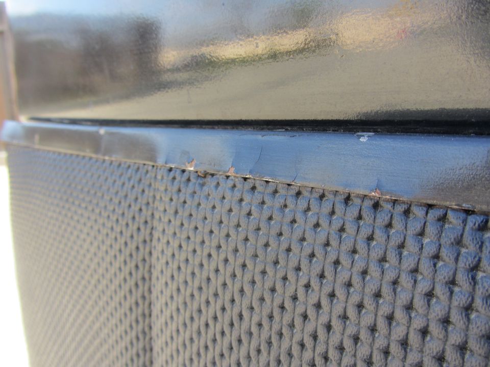 close-up of textured door panel with black trim above