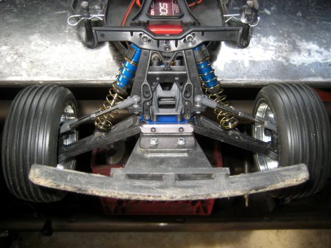 1996 Ford Bronco - Close-up view of the front suspension and tires of a remote-controlled car.