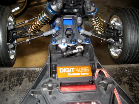 1996 Ford Bronco - The interior of a remote control car chassis shows a servo and suspension components.