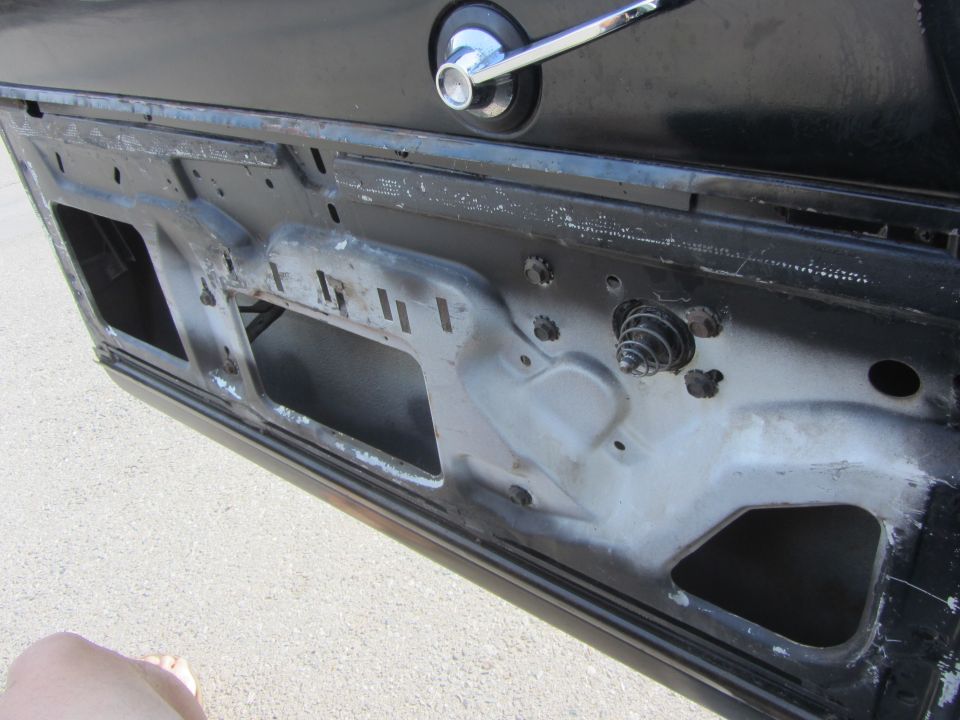 Car door interior with window mechanism visible
