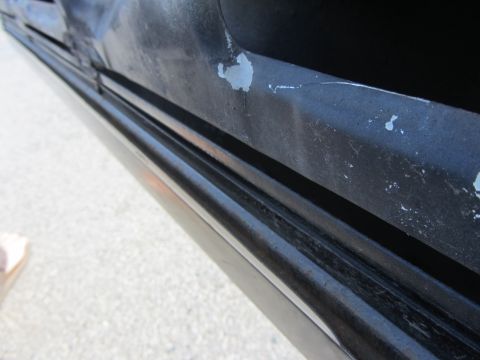 1964 Ford Ranchero - Detail shot of a car's door panel trim showing wear and chipped paint.