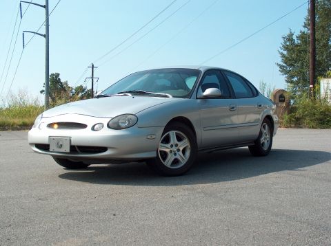 1998 Ford Taurus - Silver 1998 Ford Taurus sedan parked outdoors under a clear sky.