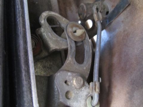 1964 Ford Ranchero - Close-up view of a vehicle's interior door latch mechanism and linkage.