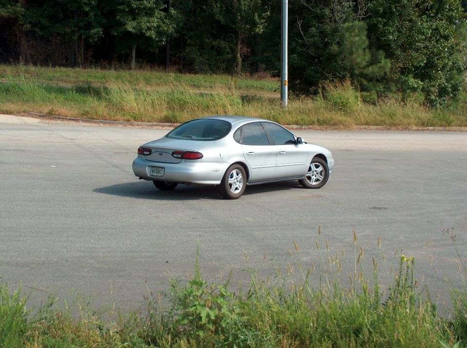Silver 1998 Ford Taurus from rear quarter view