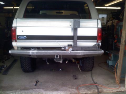 1996 Ford Bronco - The rear of a 1996 Ford Bronco is shown, a custom bumper and a swing-away spare tire carrier.