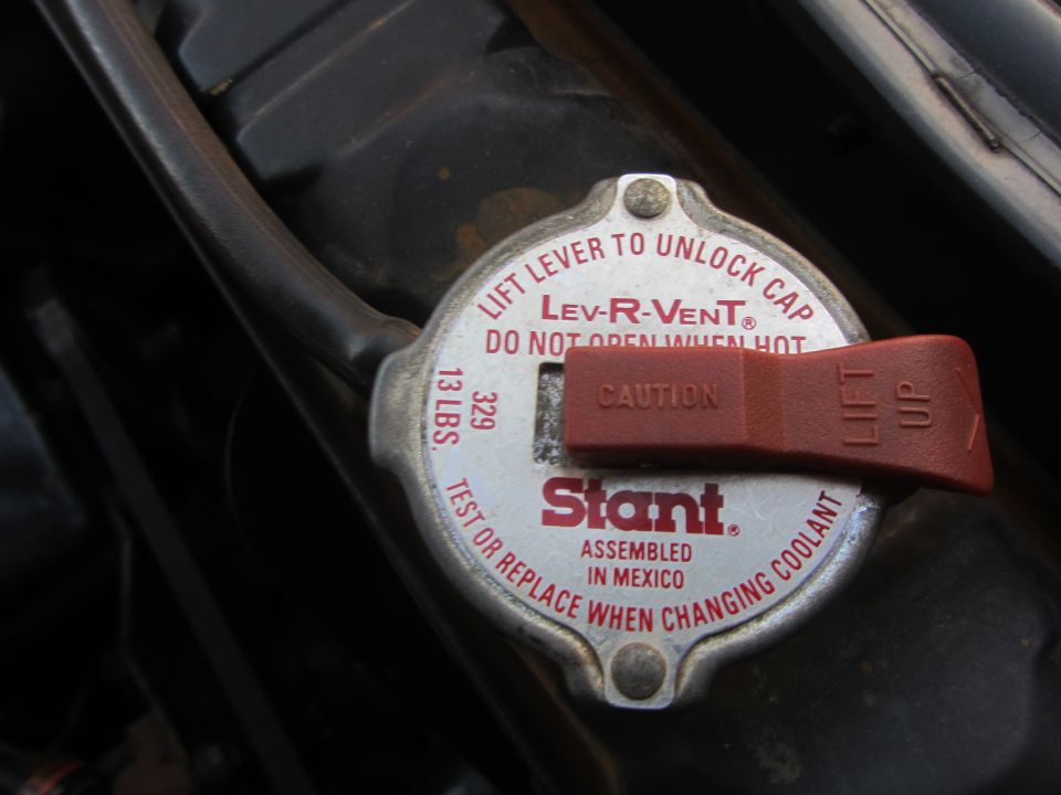 Radiator cap with red Lev-R-Vent lever, labeled 'Stant' and 'Assembled in Mexico'