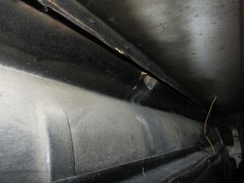 1964 Ford Ranchero - A close-up view of a dusty interior shelf with a visible yellow wire.