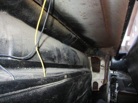 1964 Ford Ranchero - Dusty interior paneling and wiring are visible in this close-up shot of a vehicle's interior.