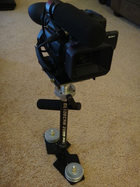 1993 Ford Taurus - A professional video camera is attached to a stabilizer rig, ready for filming.
