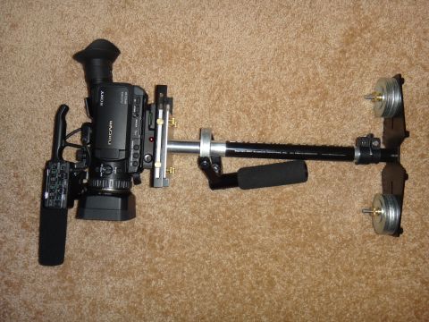 1993 Ford Taurus - A Sony NXCAM video camera is mounted on a stabilizer rig with counterweights and handles.