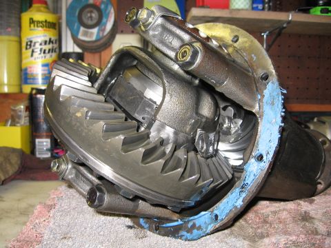 1993 Toyota 4Runner - Close-up of a vehicle differential assembly, showing gears and sealant, with workshop items in the background.