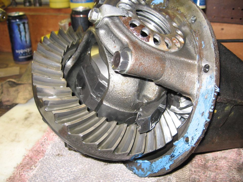 Differential gears with blue sealant on housing