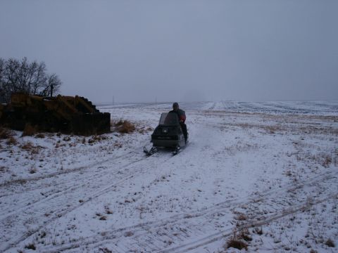 1971 Arctic Cat Panther 440 2-Pass - Riding a snowmobile through a winter landscape.