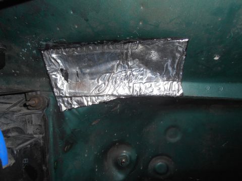 1990 Ford Bronco - Close-up of sound deadening material with visible 'Shaker Expert' branding applied to a green metal surface.
