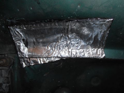 1990 Ford Bronco - Close-up of sound deadening material with embossed text, possibly from a vehicle's interior.
