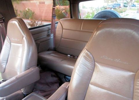 1994 Ford Bronco - The interior of a 1994 Ford Bronco Eddie Bauer edition features comfortable leather seating and a spare tire mounted in the rear.