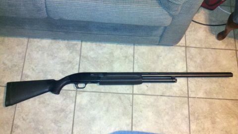 2010 Champion 188 - A shotgun is shown on a tiled floor, with a couch in the background.