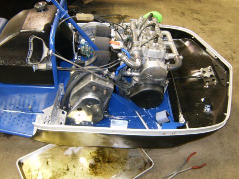 2000 Ford E350 - Close-up view of the engine bay of a snowmobile, showing the motor and associated components.