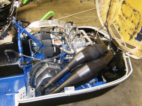 2000 Ford E350 - Close-up view of a snowmobile's engine compartment, showing the motor and exhaust system.