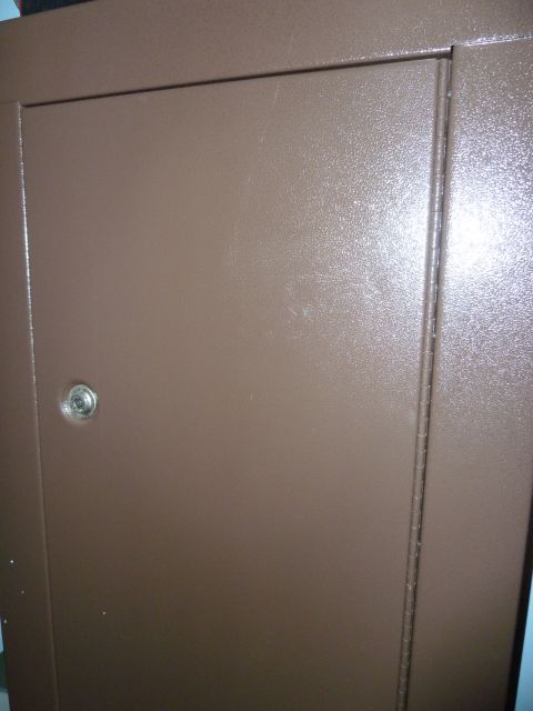 1992 Ford Mustang - Close-up view of a brown metal door a visible lock cylinder.