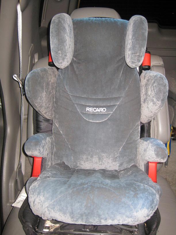 Gray Recaro car seat with red accents, seen from the front inside a vehicle