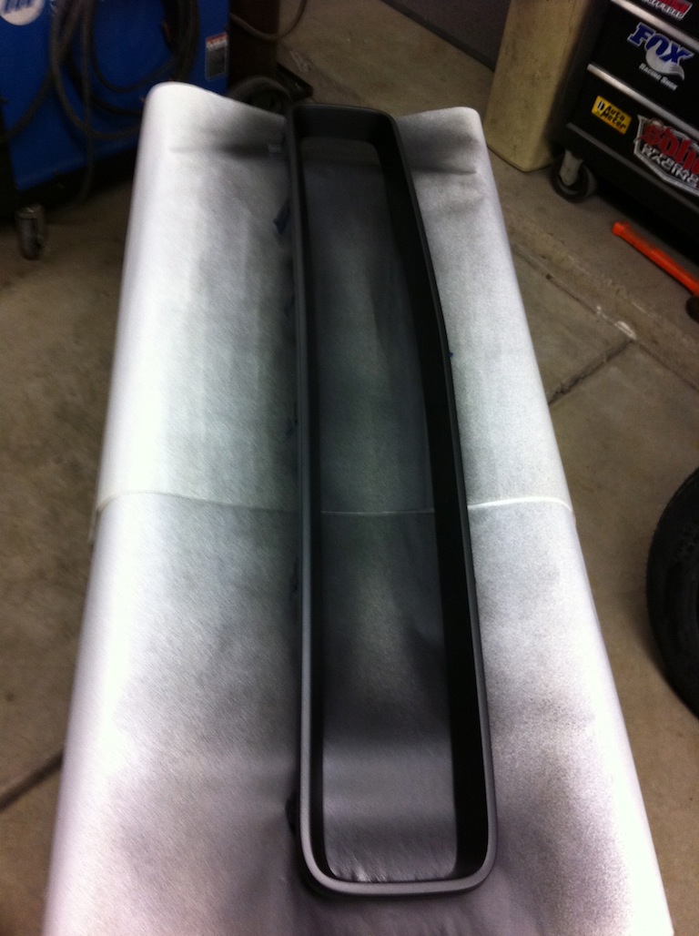 Black grille trim piece on white paper