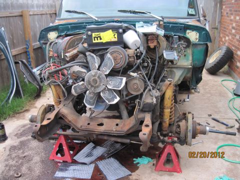 1979 Ford Bronco - Front end of a 1979 Ford Bronco disassembled for repair, showing the engine and chassis components.