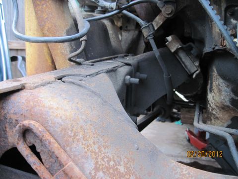 1979 Ford Bronco - Close-up view of heavily rusted frame and engine components, with a date stamp of 02/20/2012.