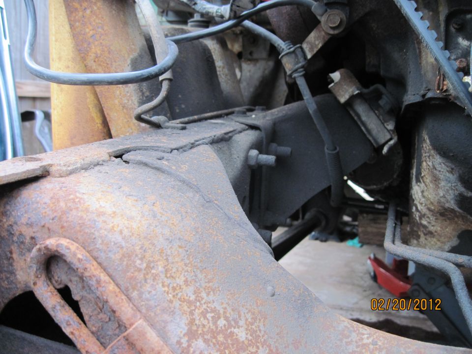Rusted frame and engine components, close-up view