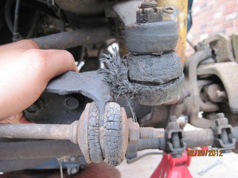 1979 Ford Bronco - Damaged ball joint and cracked bushings on a vehicle's suspension system.