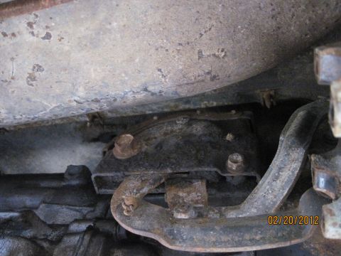 1979 Ford Bronco - Close-up view of the rusty undercarriage components of a vehicle, with a date stamp visible.