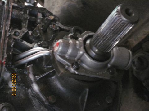1979 Ford Bronco - A close-up view shows a splined shaft connected to a metal housing, possibly part of a vehicle's steering or drivetrain system.