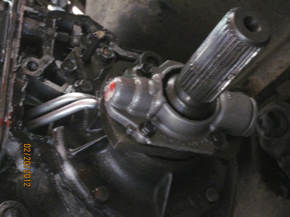 Close-up of a splined shaft connected to a metal housing with red paint marks