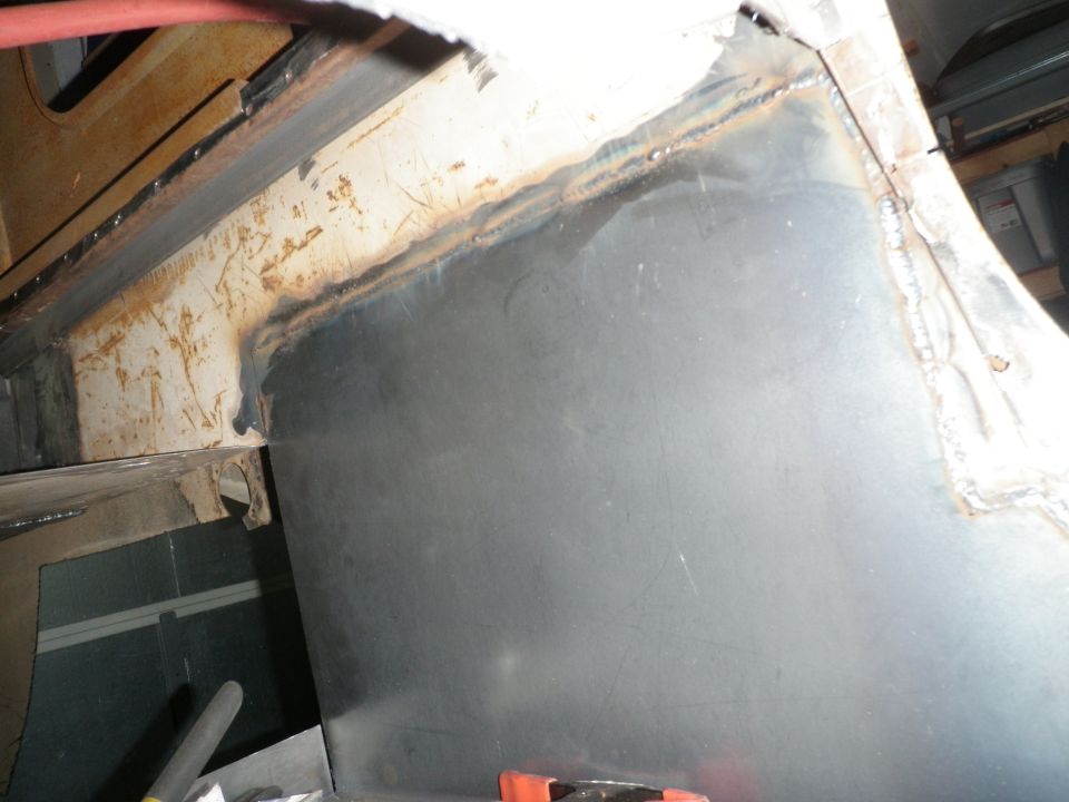Close-up of metal panel being welded onto a vehicle's frame