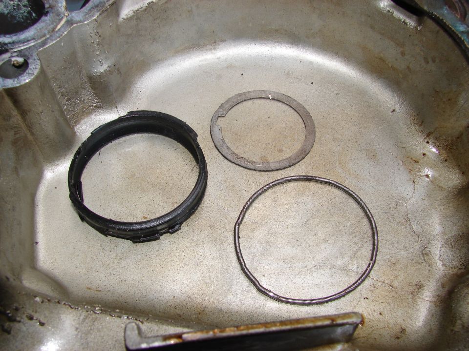 Engine oil pan with a black seal and two metal rings inside