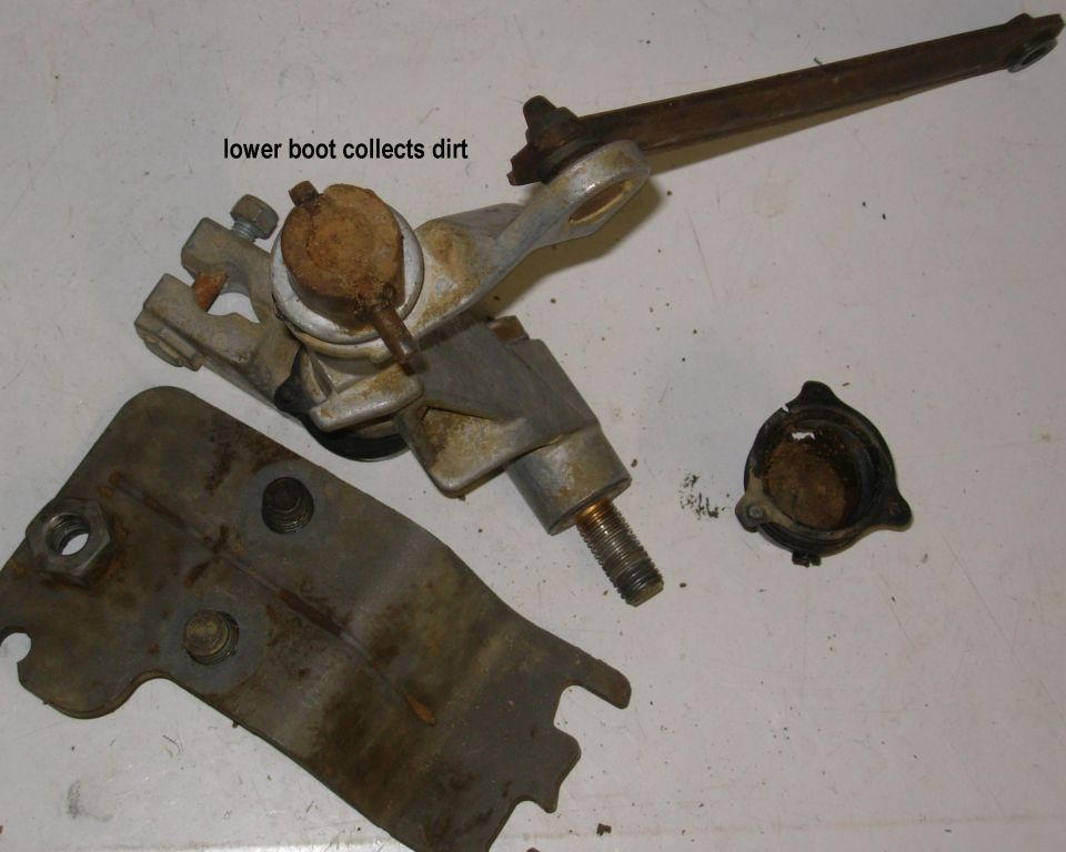 To begin, carefully cut the nylon zip-ties around the rubber boots, being careful not to cause further damage to the thin, fragile boots.  Use the tabs to separate the lower boot from the shift lever and then pull it off the short end of the pin.

Recently, Dorman has begun offering this shifter as 600-602; ~$90 on [url=http://www.amazon.com/Dorman-600-602-Shift-Linkage-Truck/dp/B003SZ3COU/]Amazon[/url].
